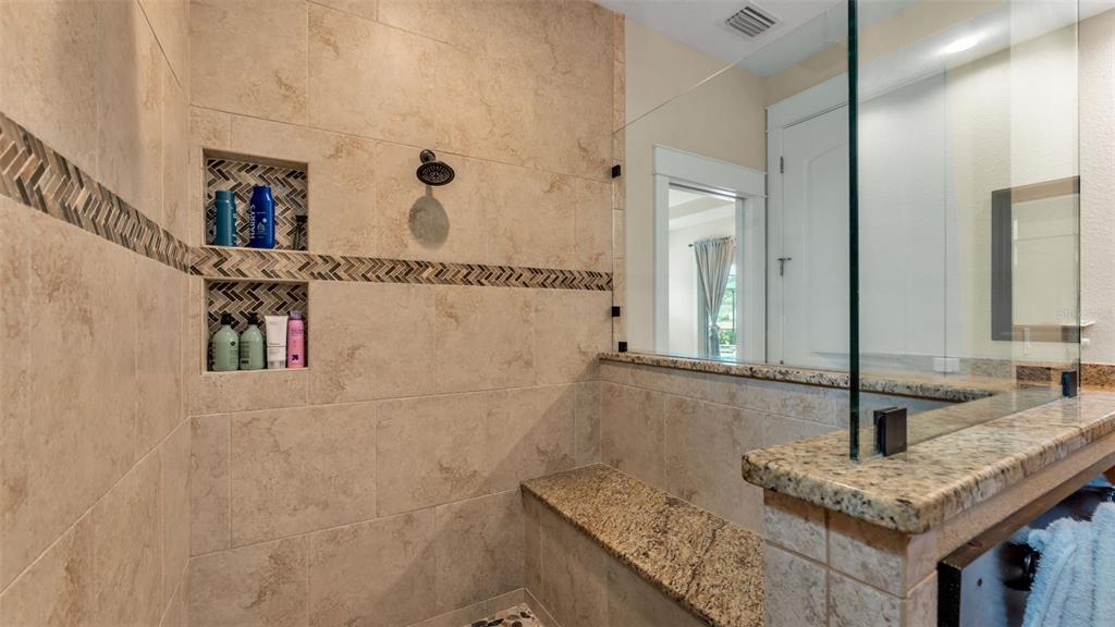 3430 North Galloway Road Lakeland, FL 33810 - Photo 28 of 84 a bathroom with a granite countertop sink a mirror and shower