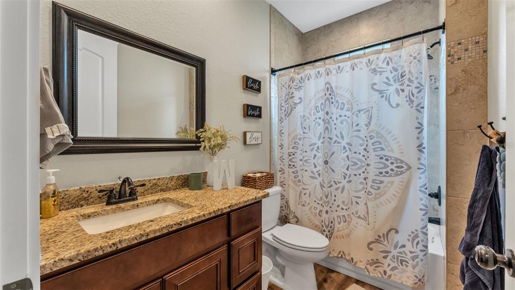 3430 North Galloway Road Lakeland, FL 33810 - Photo 33 of 84 a bathroom with a granite countertop sink toilet and shower