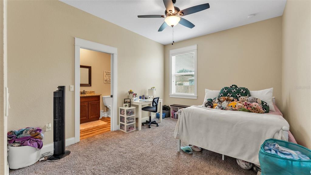 3430 North Galloway Road Lakeland, FL 33810 - Photo 36 of 84 a bedroom with furniture and a chandelier