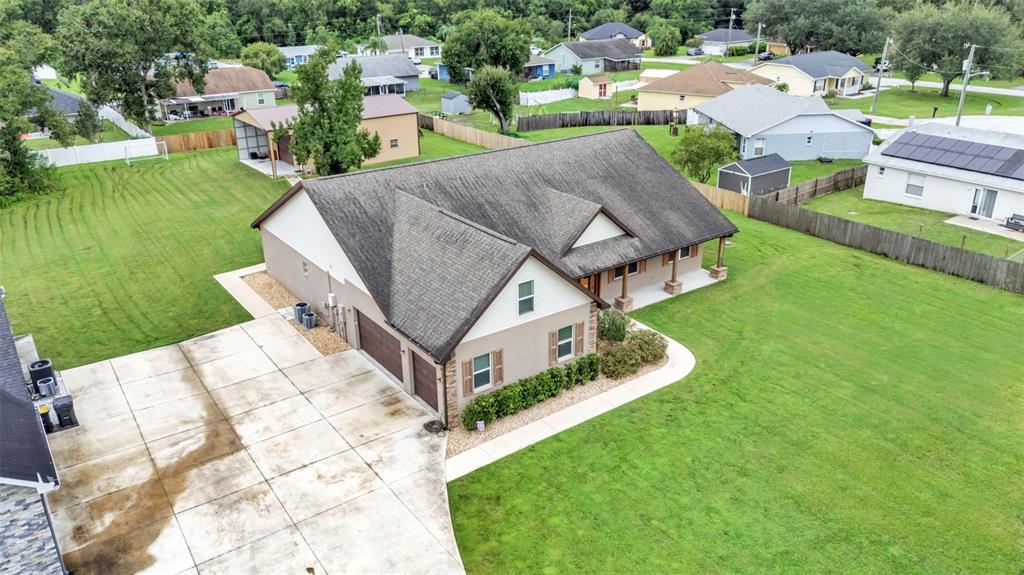 3430 North Galloway Road Lakeland, FL 33810 - Photo 69 of 84 a aerial view of a house with a yard table and chairs