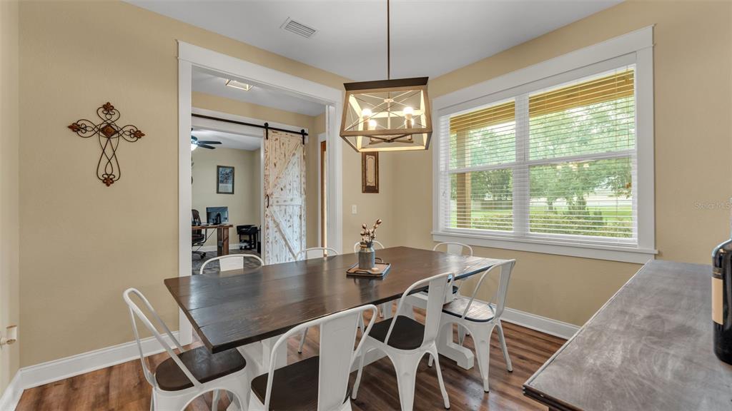 3430 North Galloway Road Lakeland, FL 33810 - Photo 10 of 84 a view of a dining room with furniture window and wooden floor