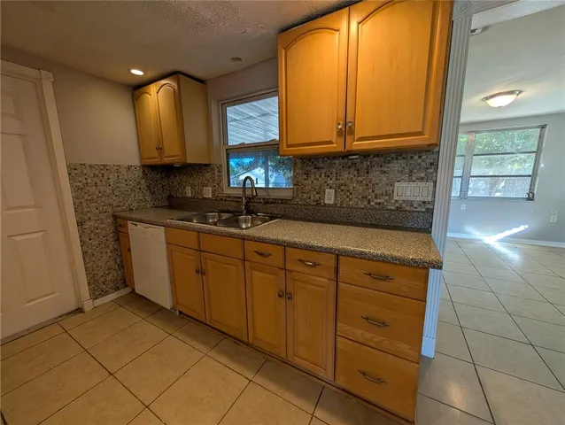 a kitchen with stainless steel appliances granite countertop a sink and cabinets