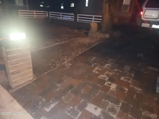 a view of a refrigerator in an empty room