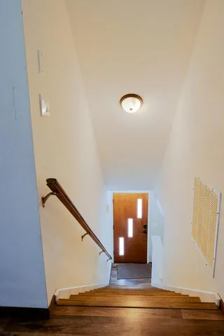 a view of a room with wooden floor