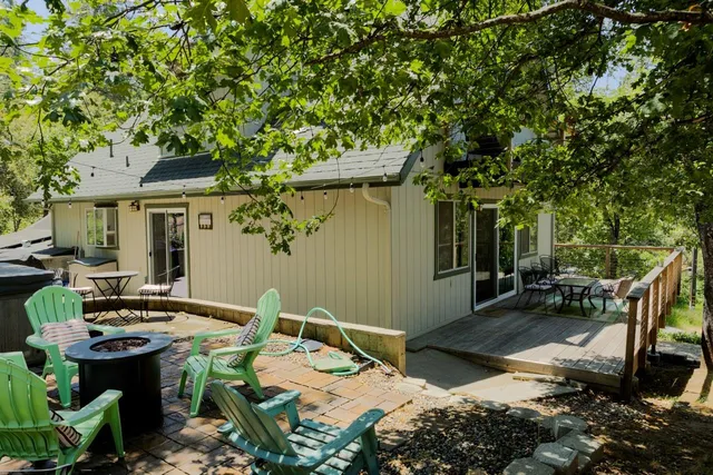 a view of backyard of house with seating area