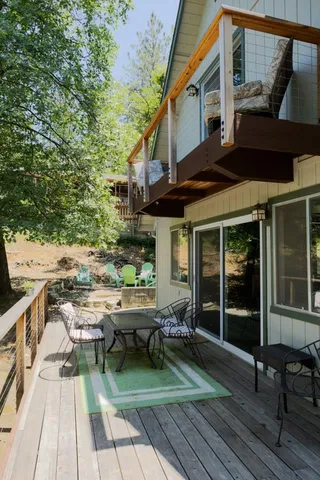a view of a patio with table and chairs and wooden floor