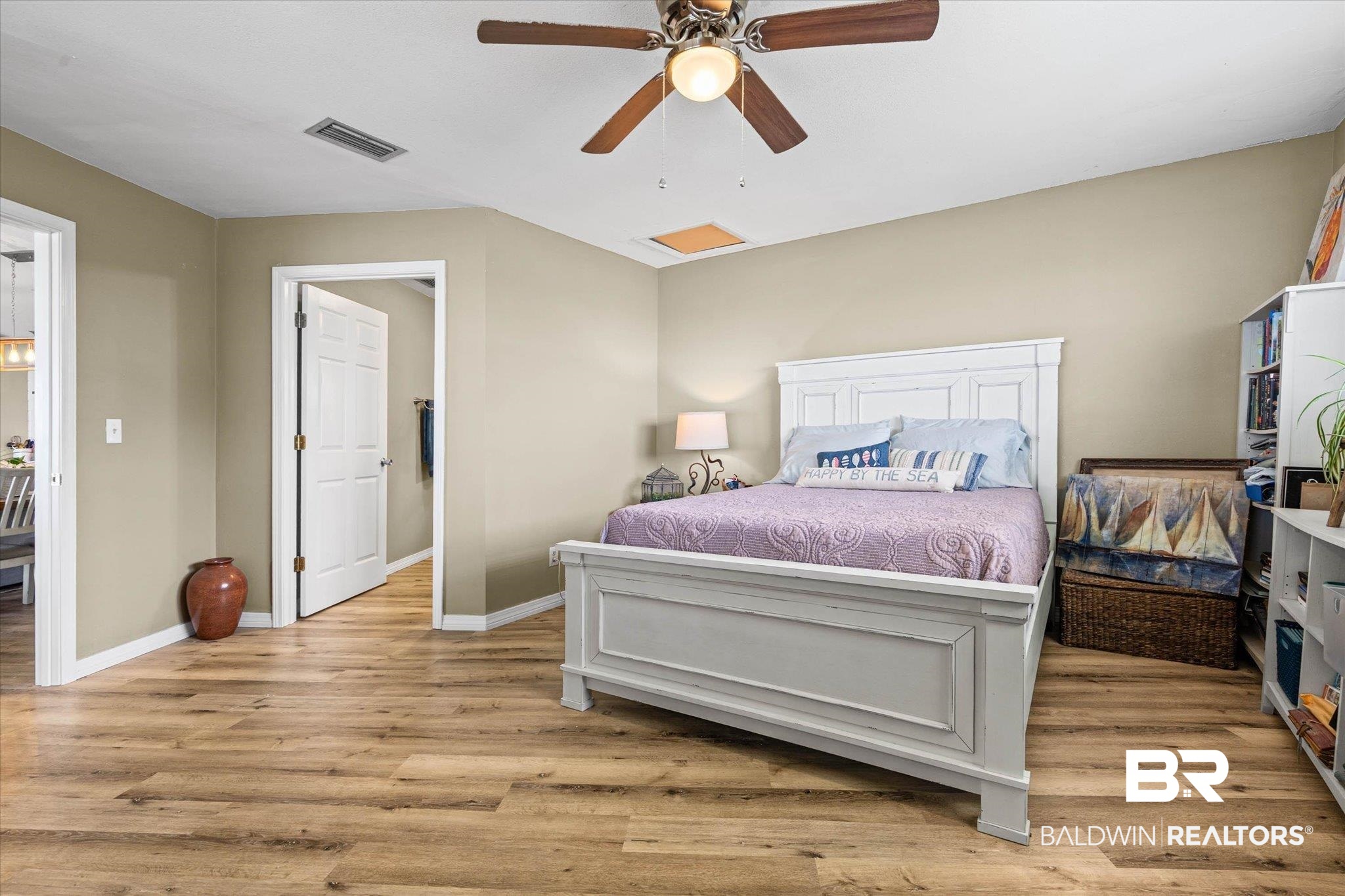 9100 Shell Belt Road Coden, AL 36523 - Photo 12 of 38 Bedroom featuring wood-finish flooring, a ceiling fan with light fixture, and neutral painted walls