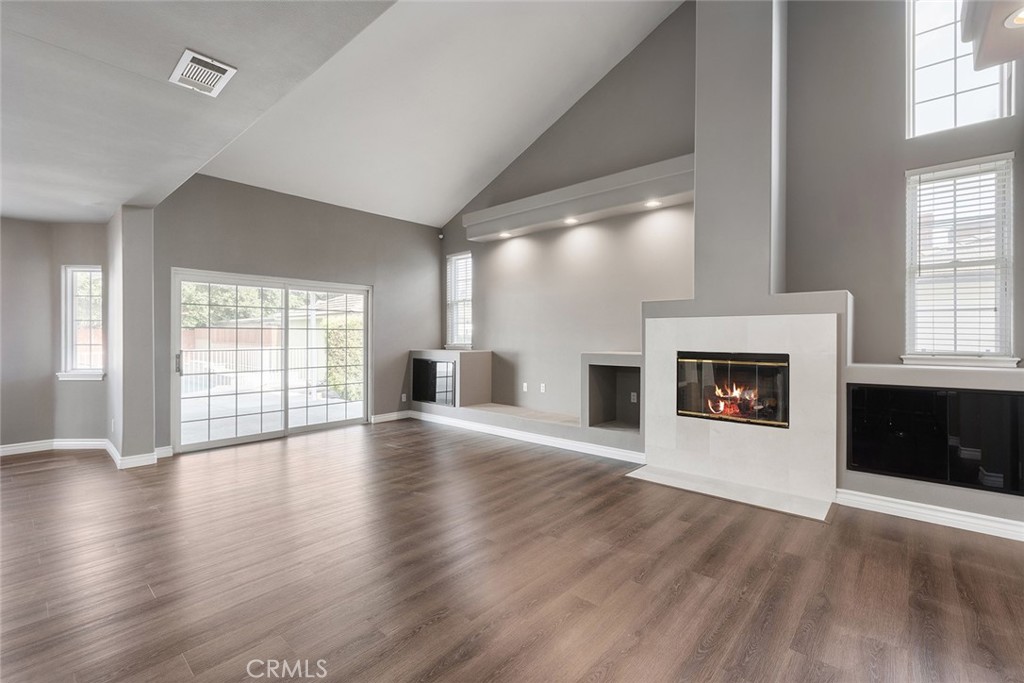 849 Balboa Drive Arcadia, CA 91007 - Photo 28 of 54 an empty room with wooden floor fireplace and windows