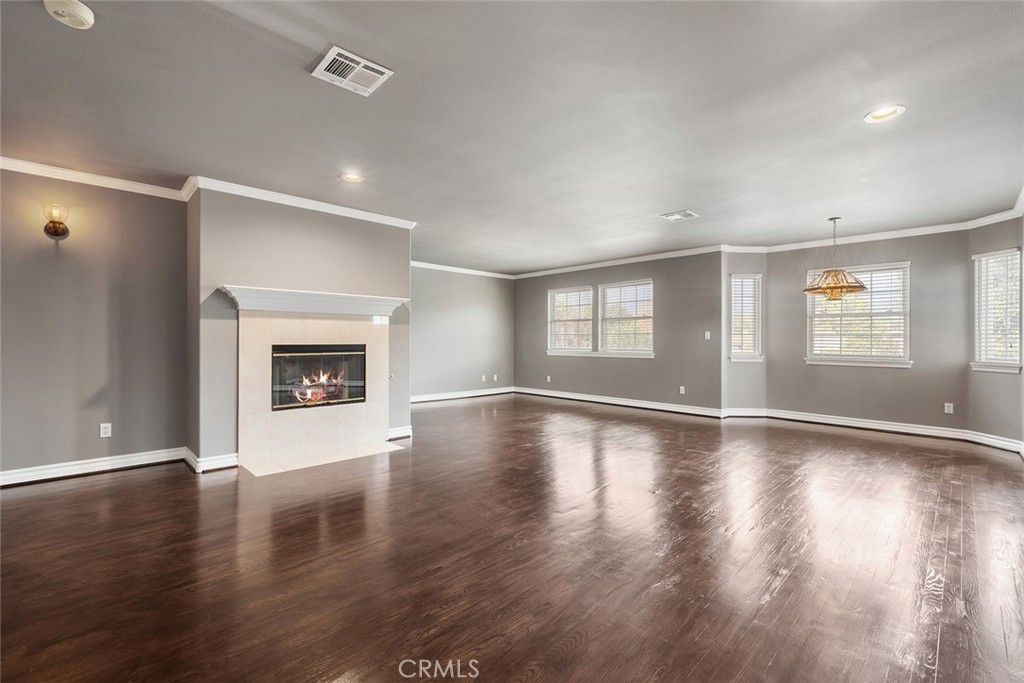 849 Balboa Drive Arcadia, CA 91007 - Photo 35 of 54 an empty room with wooden floor fireplace and windows