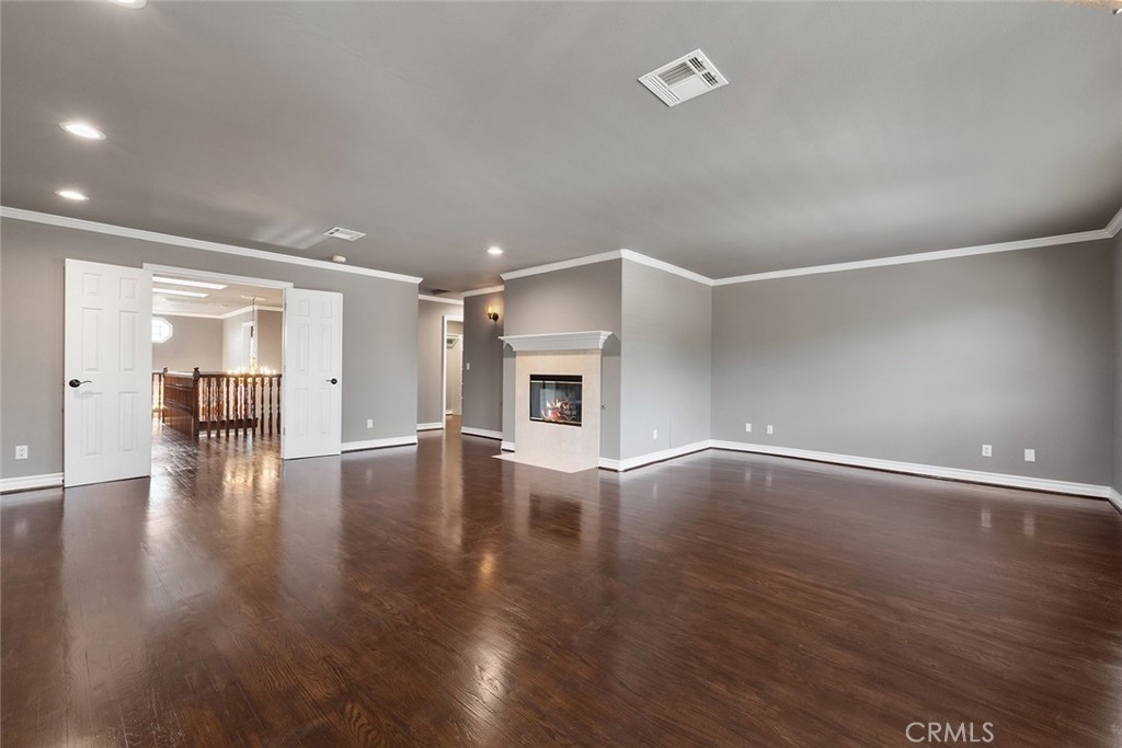 849 Balboa Drive Arcadia, CA 91007 - Photo 38 of 54 an empty room with wooden floor and fireplace