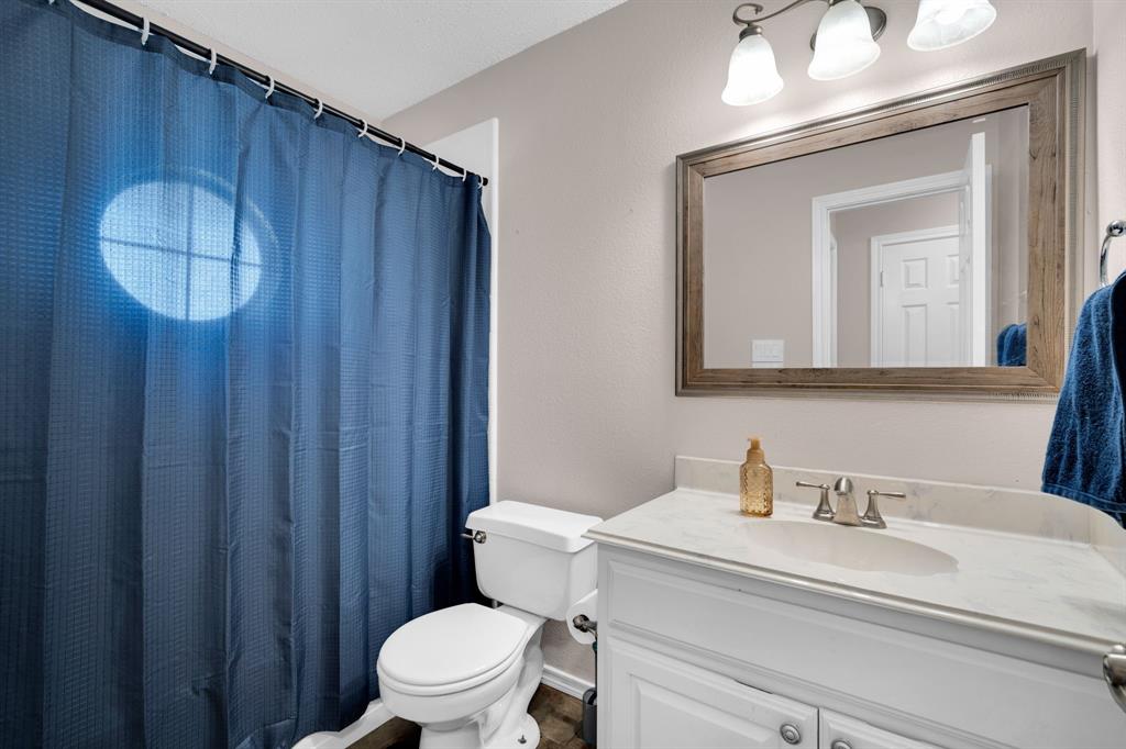 1001 Short Line Boulevard Midlothian, TX 76065 - Photo 11 of 26 Bathroom featuring a white vanity with an integrated sink, a rectangular framed mirror, and a three-light fixture