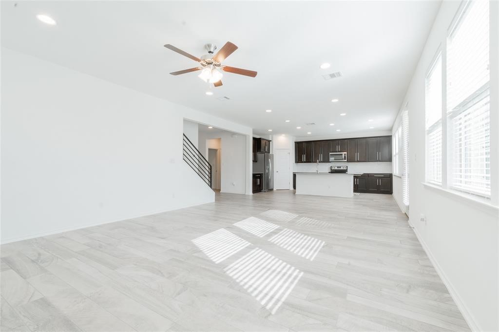 1333 Terrace View Drive Georgetown, TX 78628 - Photo 7 of 35 Natural light floods this open-concept area featuring a kitchen with an island, ideal for modern living.