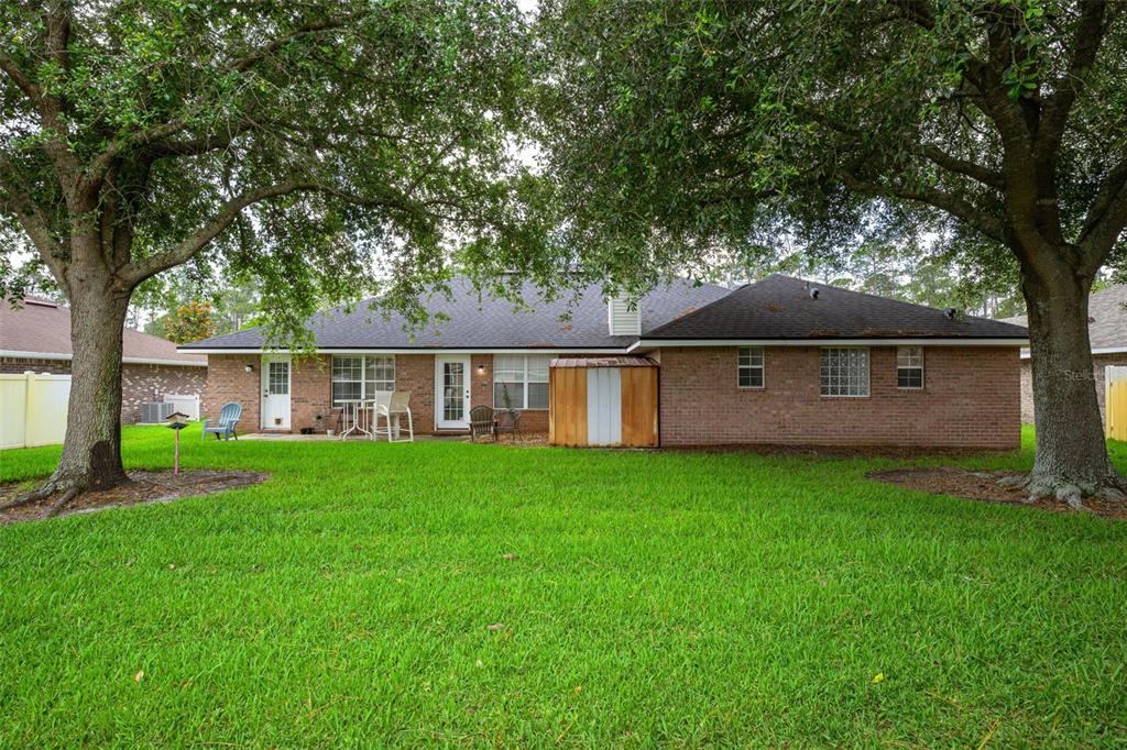 11 Riddle Drive Palm Coast, FL 32164 - Photo 23 of 33 a front view of a house with yard and green space