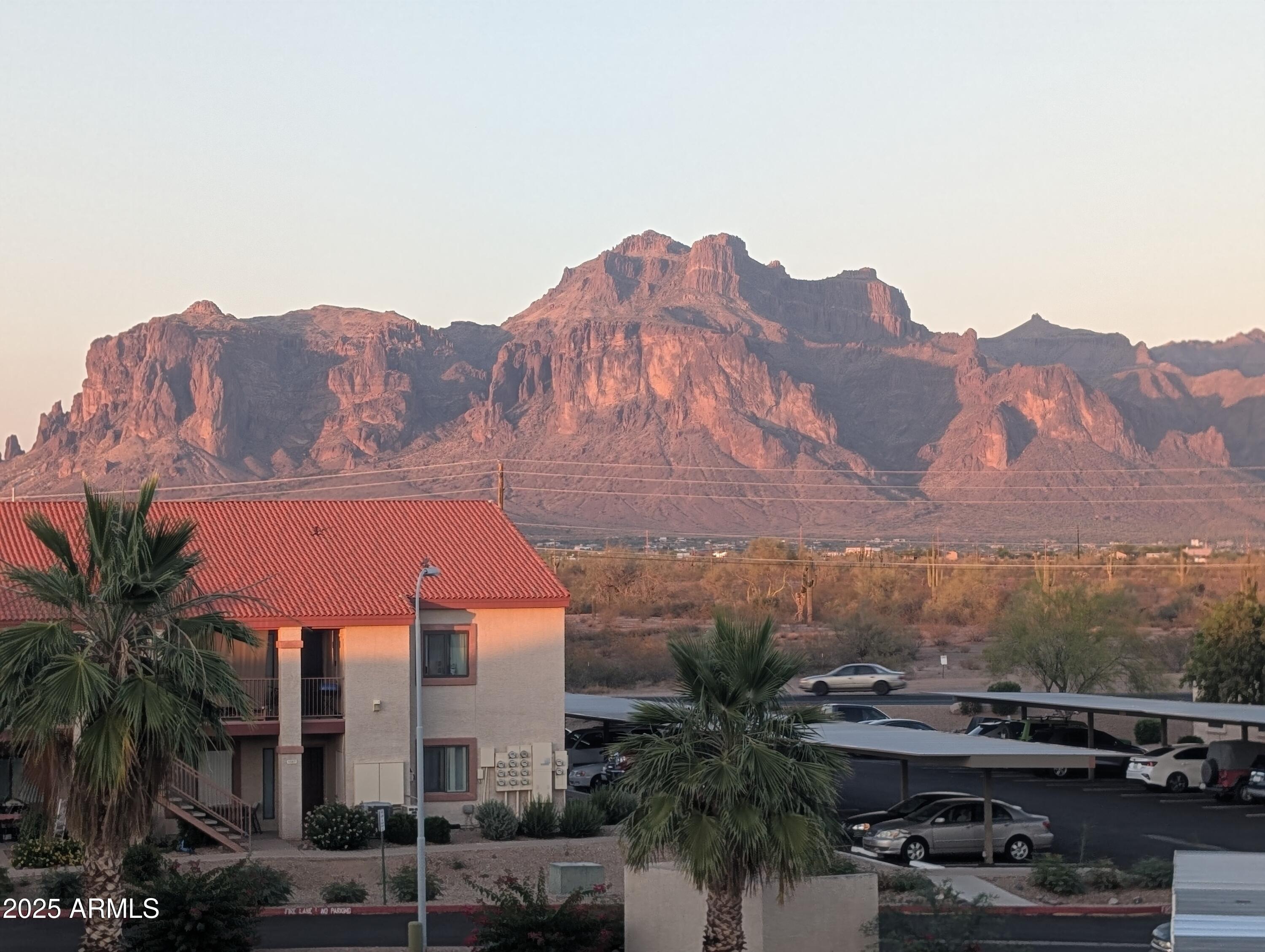 1440 North Idaho Road, Unit 2050 Apache Junction, AZ 85119 - Photo 1 of 21 a view of a house with a mountain in the background