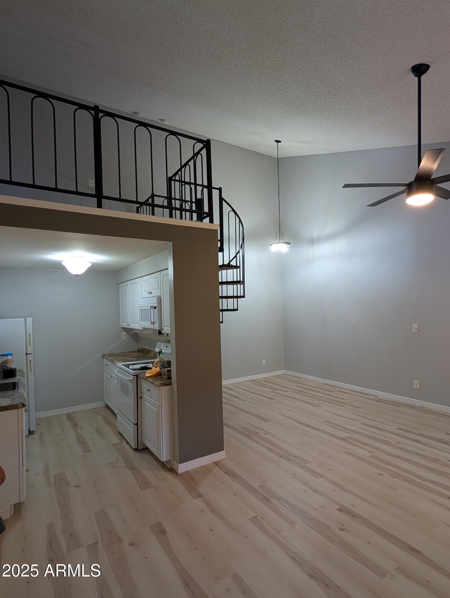 1440 North Idaho Road, Unit 2050 Apache Junction, AZ 85119 - Photo 4 of 21 a view of a kitchen with furniture and wooden floor