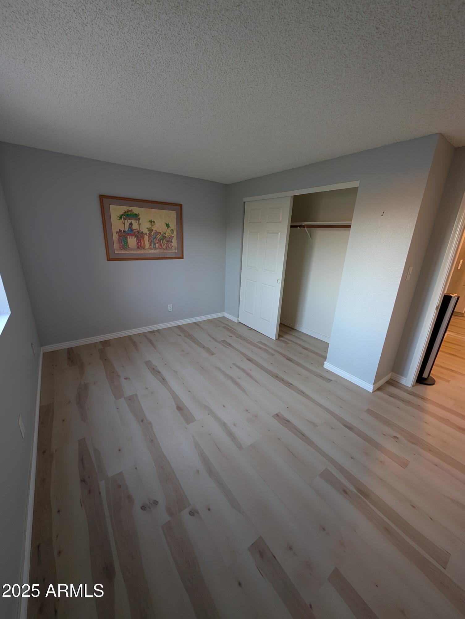 1440 North Idaho Road, Unit 2050 Apache Junction, AZ 85119 - Photo 10 of 21 a view of an empty room with wooden floor