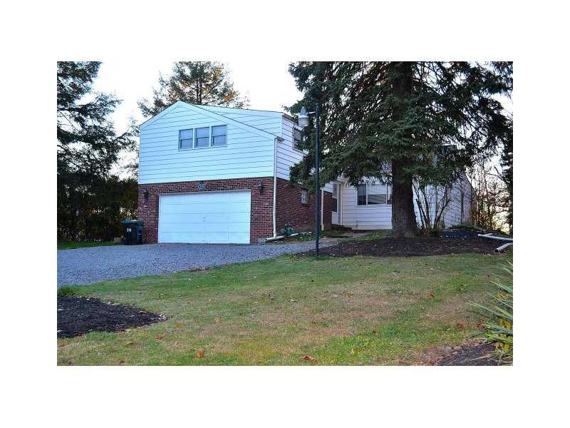 225 Ridge Road Sewickley, PA 15143 - Photo 1 of 25 Exterior Front. The home has a brick and aluminum exterior with a two-car attached garage. The garage has a door to access the side yard. A stone walkway leads to front door.