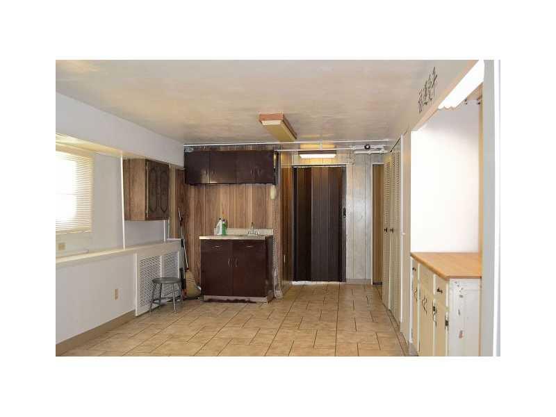 225 Ridge Road Sewickley, PA 15143 - Photo 15 of 25 Basement/Game Room. The game room is accessed from the kitchen or the garage. This area houses a sink which could be converted in a bar area, a pantry, the utility and laundry rooms , a powder room and access to a crawl space .