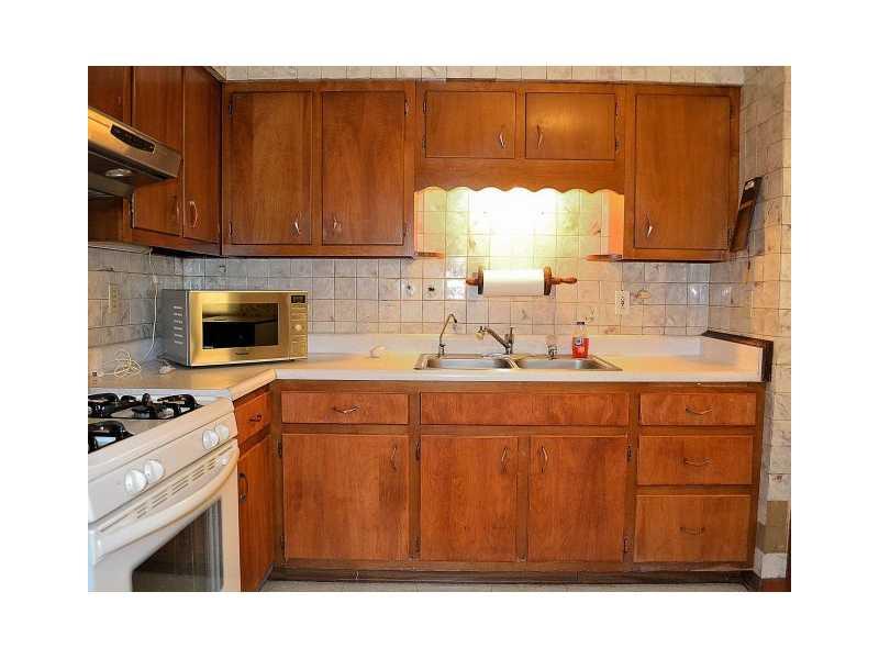 225 Ridge Road Sewickley, PA 15143 - Photo 10 of 25 Kitchen. The kitchen has a full array of appliances: refrigerator, gas stove, microwave and a portable dishwasher.