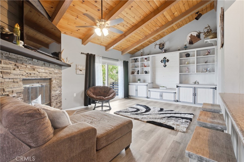 26201 Cumberland Road Tehachapi, CA 93561 - Photo 7 of 36 a living room with furniture a fireplace and a flat screen tv