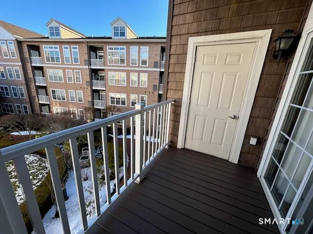 a view of a balcony with wooden floor and stairs