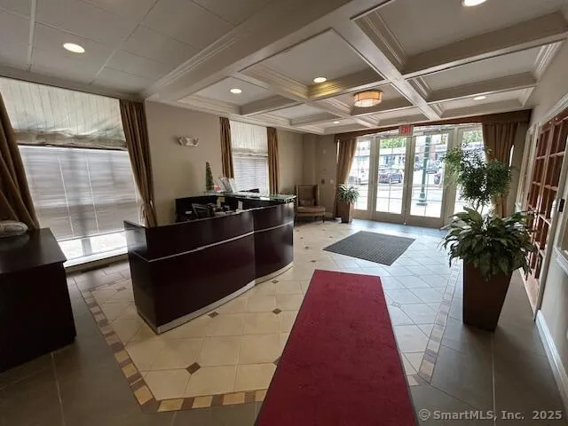 a lobby with furniture and floor to ceiling window