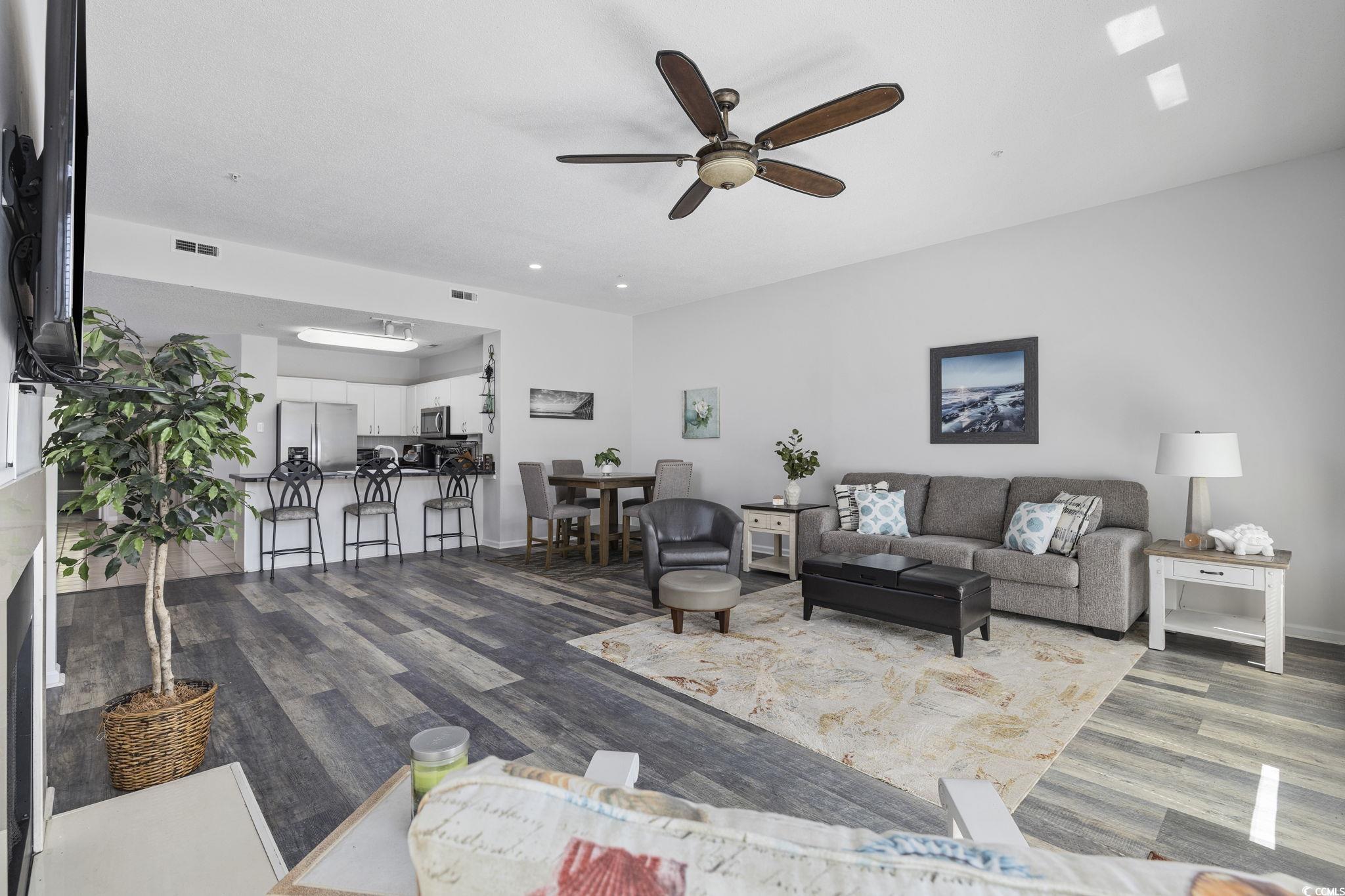 1221 Tidewater Drive, Unit 412 North Myrtle Beach, SC 29582 - Photo 12 of 36 Living room with ceiling fan and dark wood finished floors