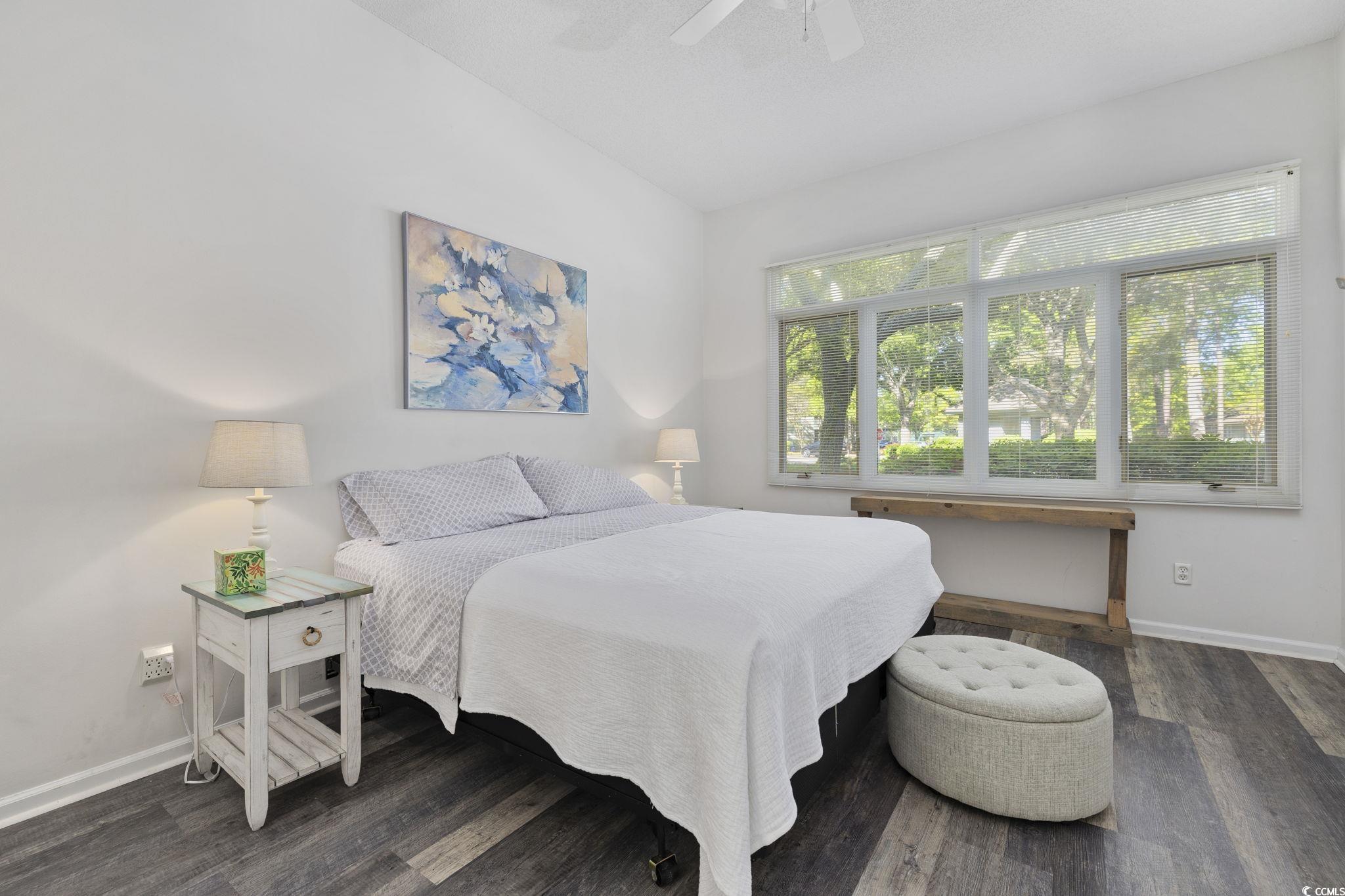 1221 Tidewater Drive, Unit 412 North Myrtle Beach, SC 29582 - Photo 15 of 36 Bedroom featuring dark wood-style floors and a ceiling fan