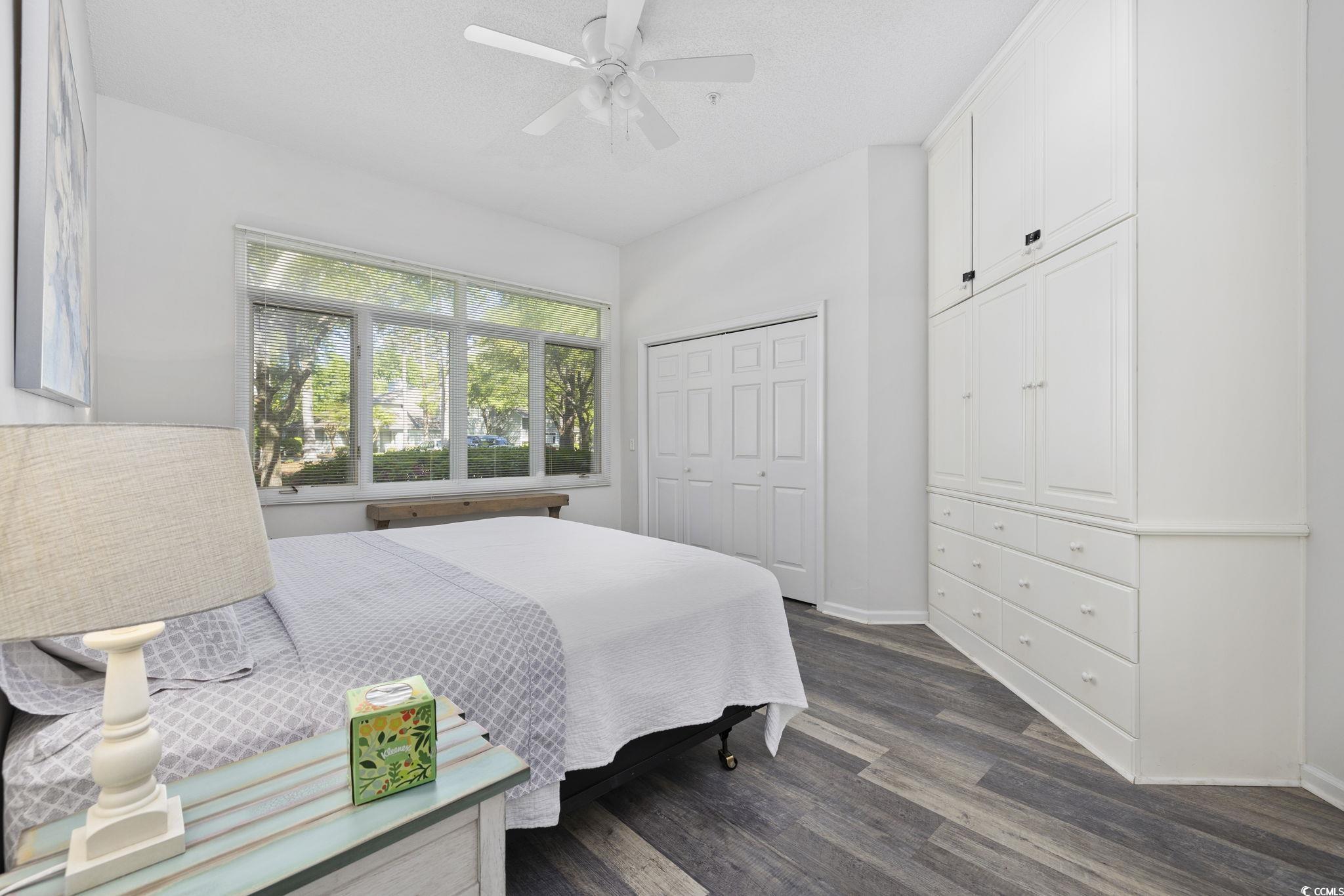 1221 Tidewater Drive, Unit 412 North Myrtle Beach, SC 29582 - Photo 16 of 36 Bedroom with a closet, dark wood-type flooring, and ceiling fan
