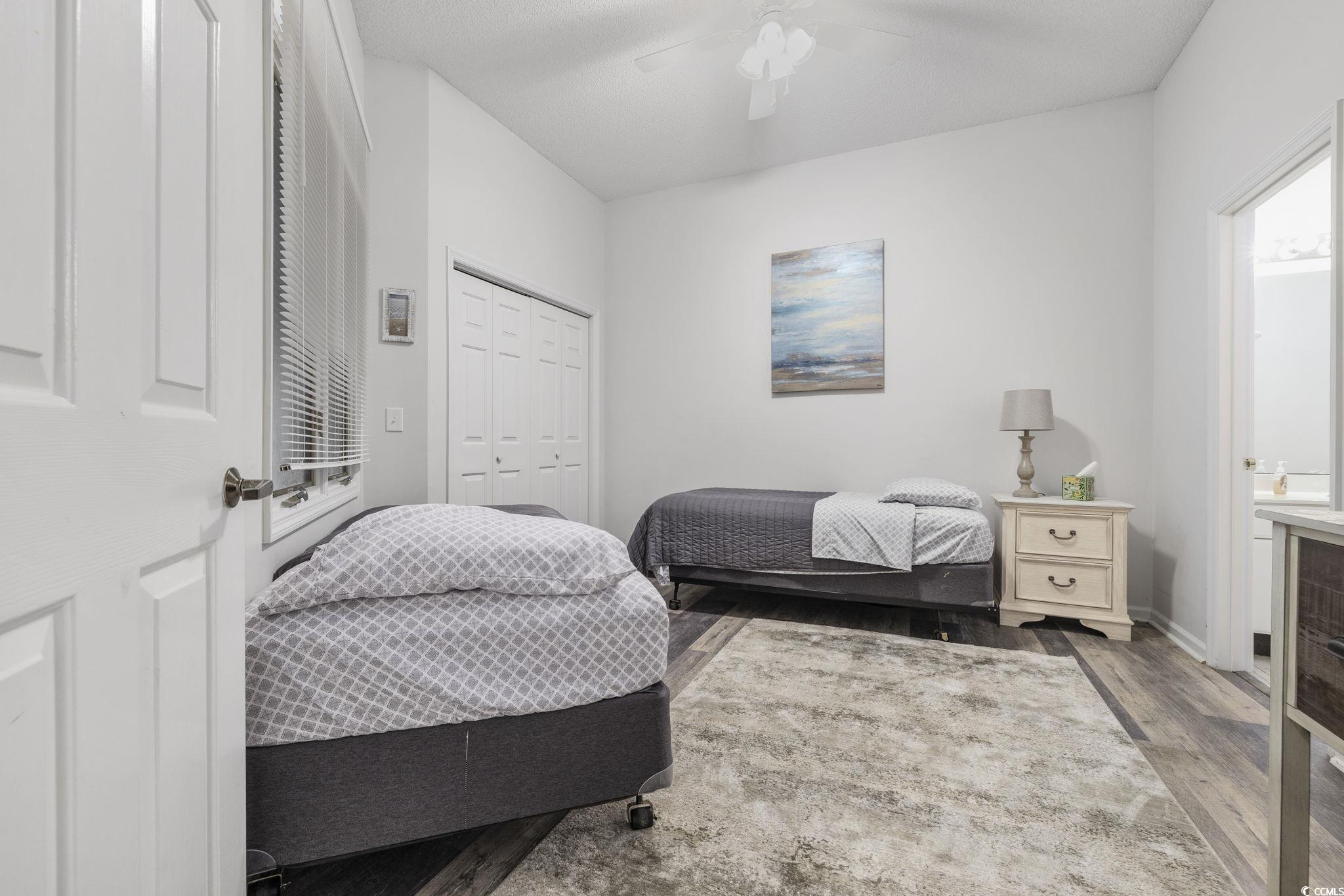 1221 Tidewater Drive, Unit 412 North Myrtle Beach, SC 29582 - Photo 20 of 36 Bedroom with a closet, wood finished floors, and ceiling fan