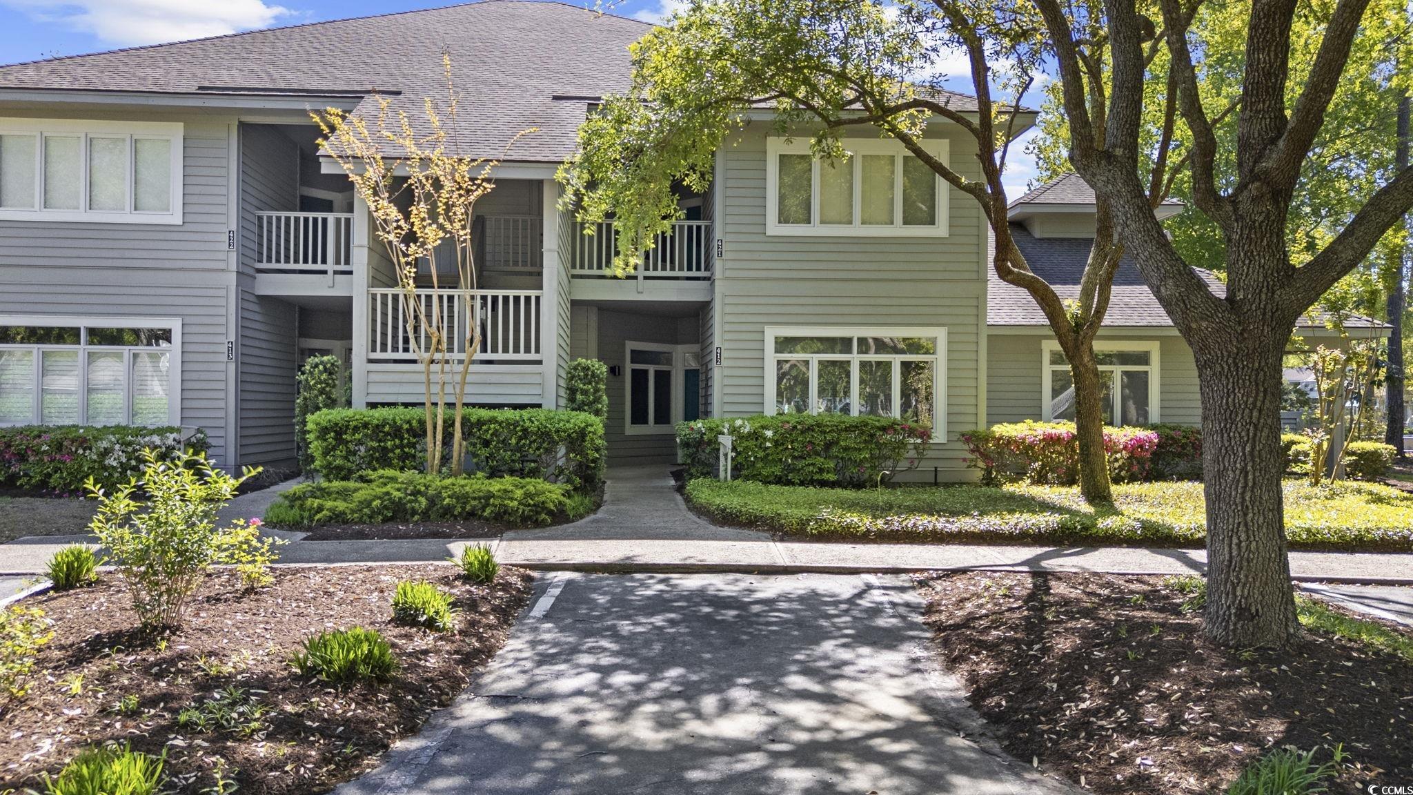 1221 Tidewater Drive, Unit 412 North Myrtle Beach, SC 29582 - Photo 2 of 36 View of front of property with roof with shingles and a balcony