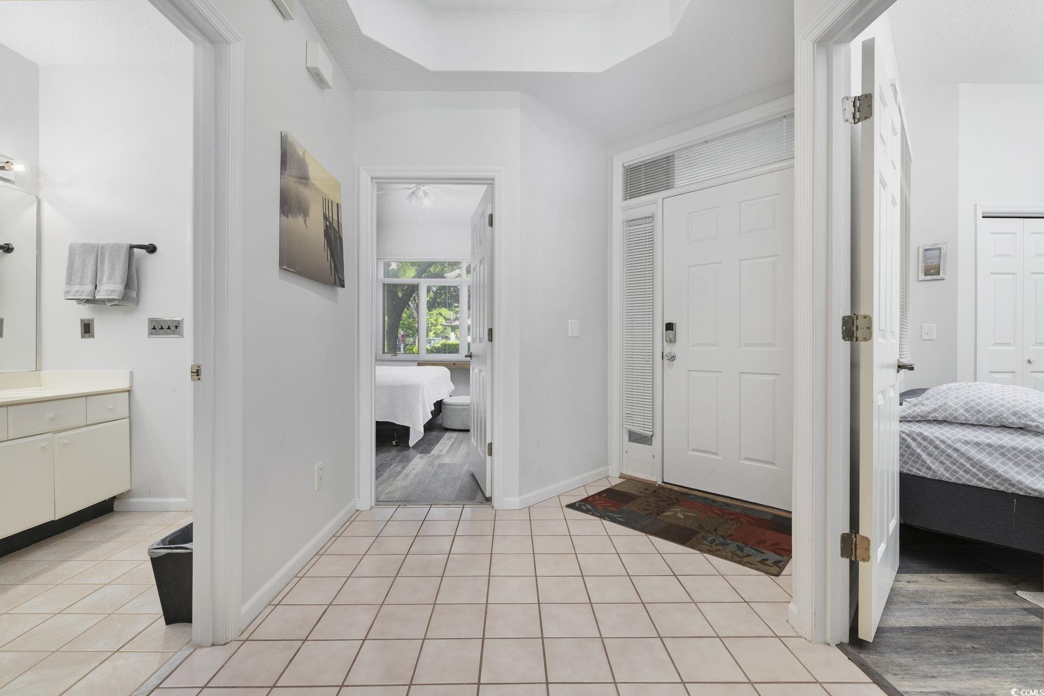 1221 Tidewater Drive, Unit 412 North Myrtle Beach, SC 29582 - Photo 23 of 36 Entryway featuring a raised ceiling and light tile patterned flooring