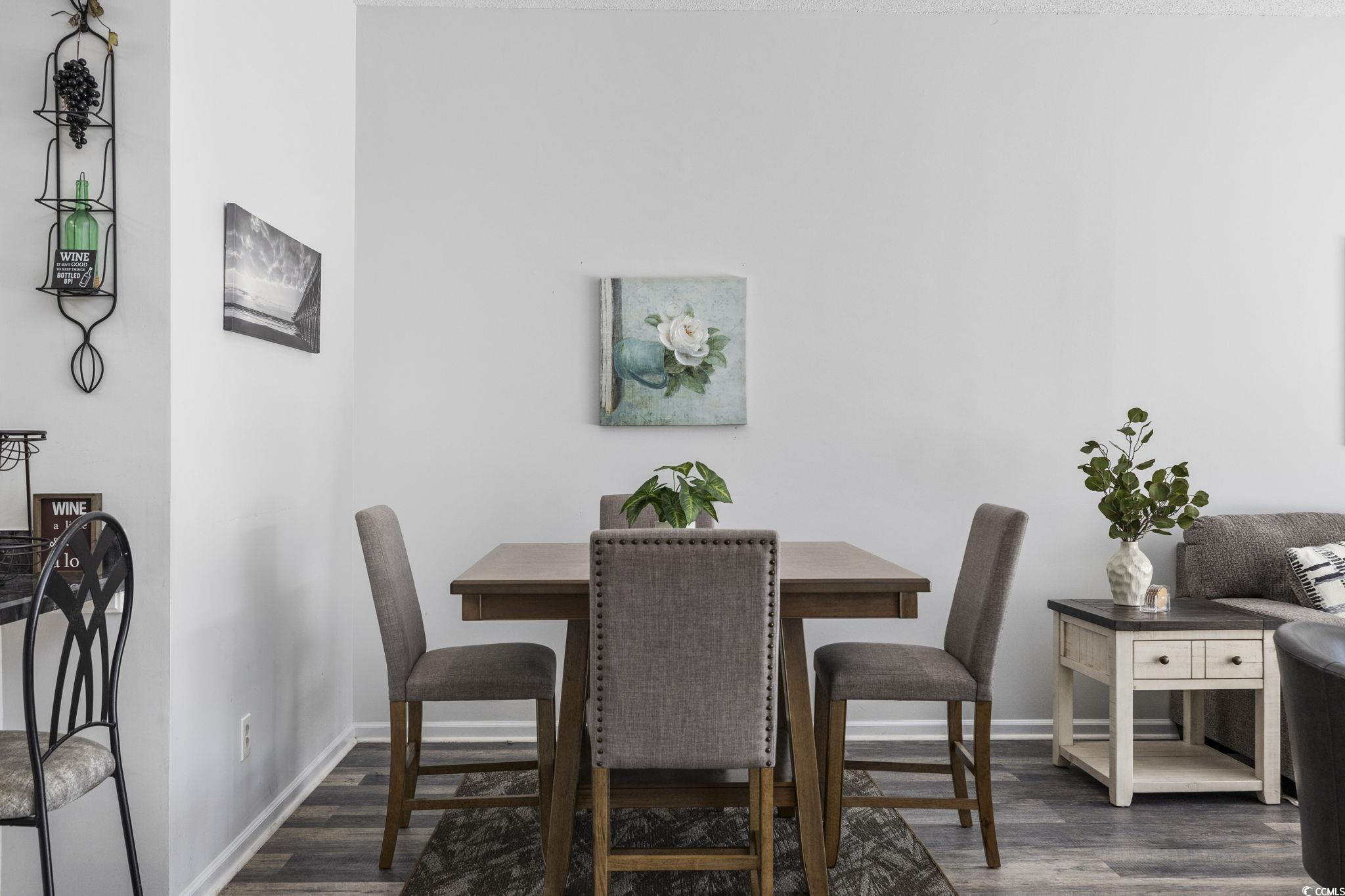 1221 Tidewater Drive, Unit 412 North Myrtle Beach, SC 29582 - Photo 9 of 36 Dining space with dark wood-style floors and baseboards