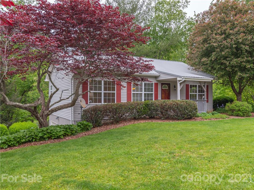 100 Ridgeline Road Clyde, NC 28721 - Photo 2 of 26 a front view of a house with a garden