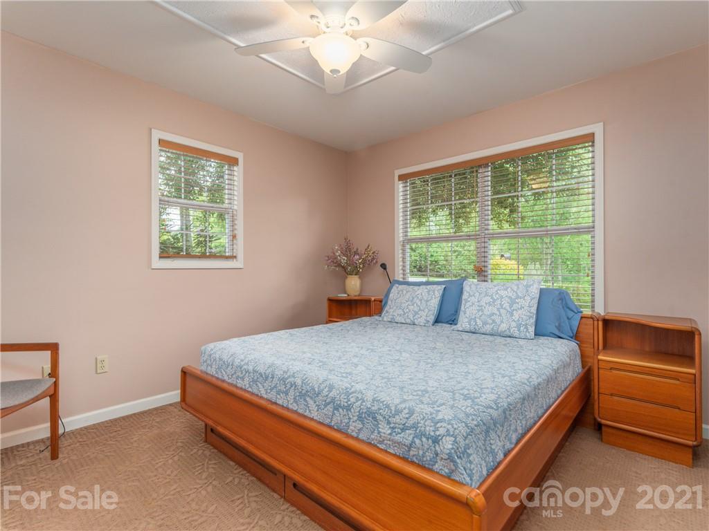 100 Ridgeline Road Clyde, NC 28721 - Photo 12 of 26 a bed sitting in a bedroom next to a window