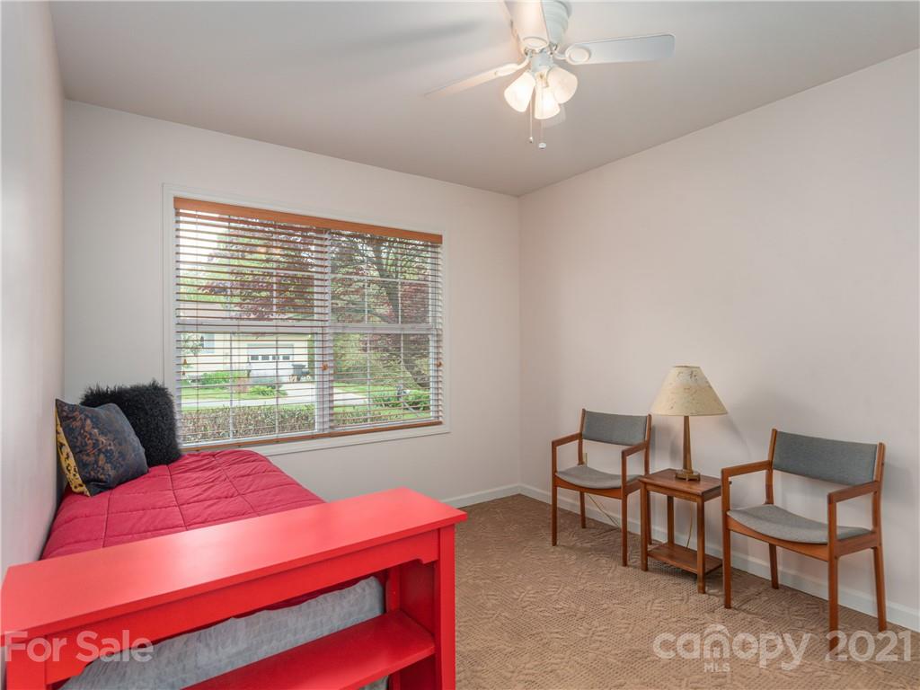 100 Ridgeline Road Clyde, NC 28721 - Photo 14 of 26 a bedroom with a bed and a chair