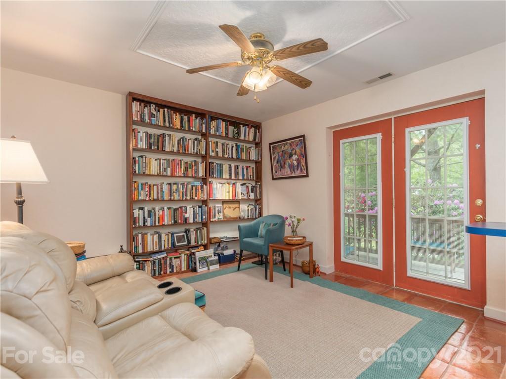 100 Ridgeline Road Clyde, NC 28721 - Photo 16 of 26 a living room with furniture and a book shelf