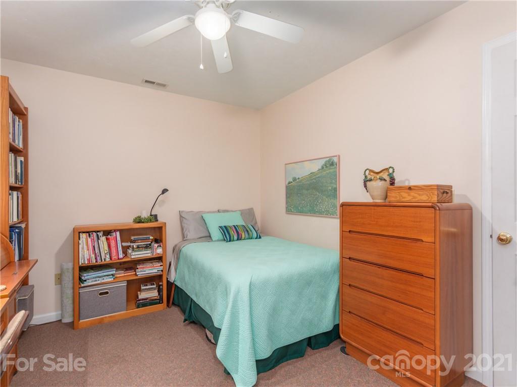 100 Ridgeline Road Clyde, NC 28721 - Photo 19 of 26 a bedroom with a bed and a dresser