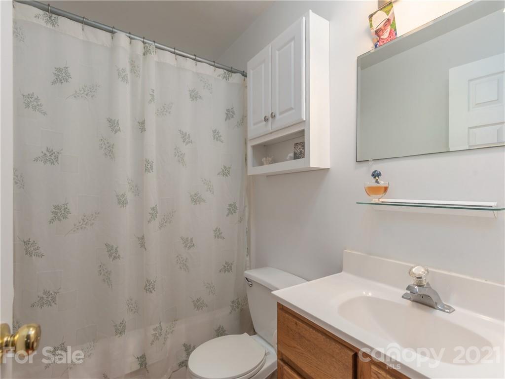 100 Ridgeline Road Clyde, NC 28721 - Photo 20 of 26 a bathroom with a sink toilet and mirror