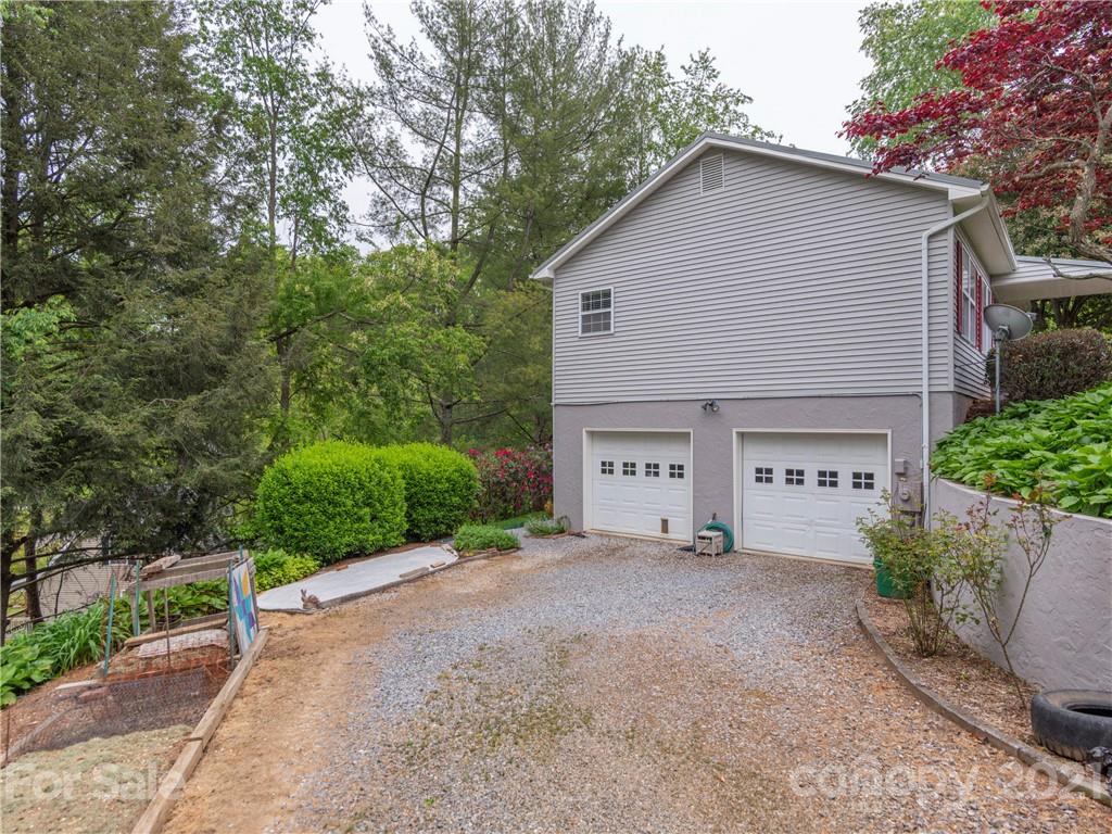 100 Ridgeline Road Clyde, NC 28721 - Photo 25 of 26 a view of a house with a yard and plants