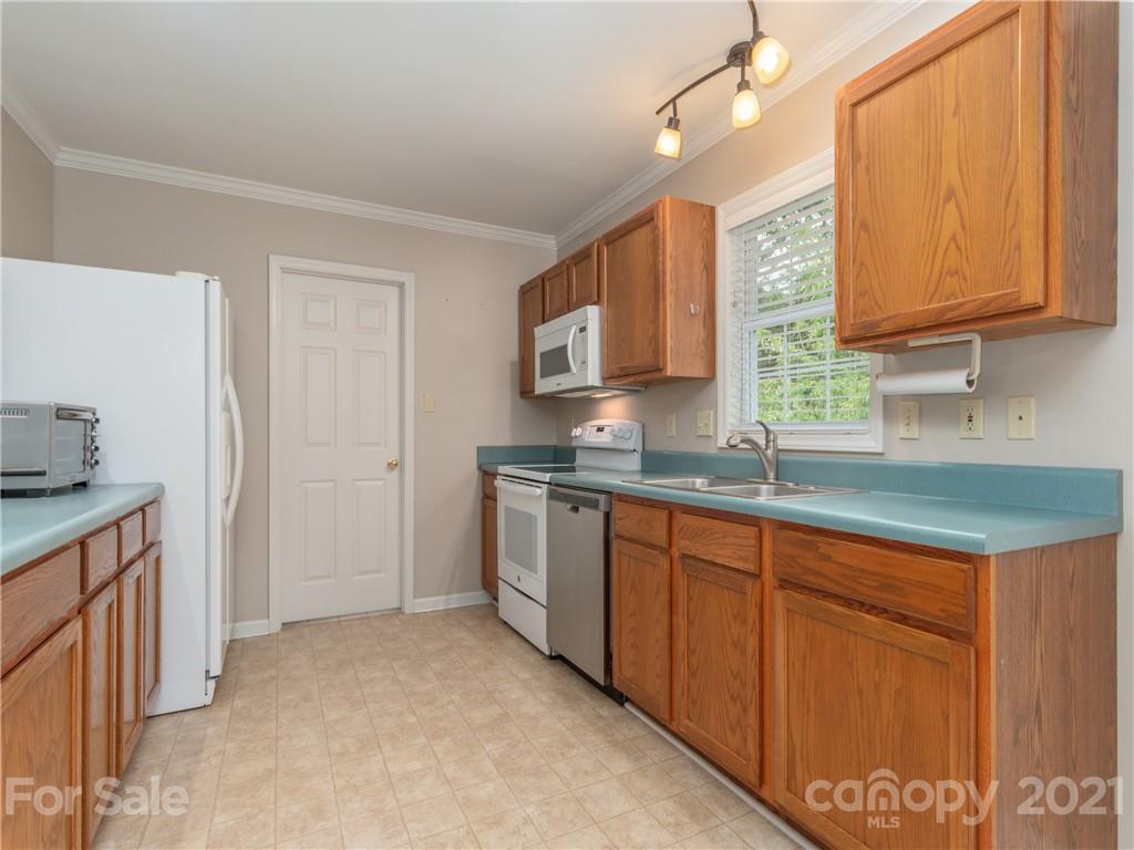 100 Ridgeline Road Clyde, NC 28721 - Photo 9 of 26 a kitchen with stainless steel appliances granite countertop a sink stove and cabinets