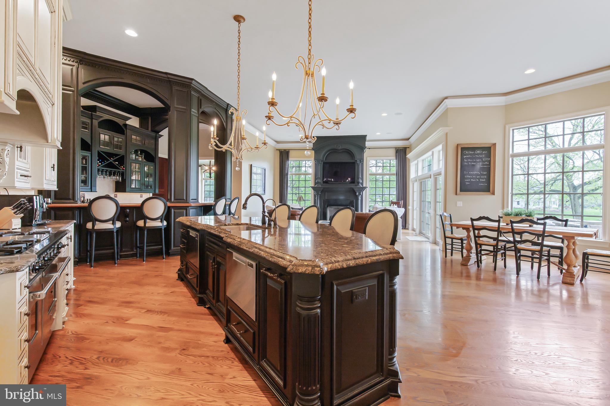 618 Willow Green Lititz, PA 17543 - Photo 21 of 63 a kitchen with stainless steel appliances granite countertop a stove and a dining table with chairs