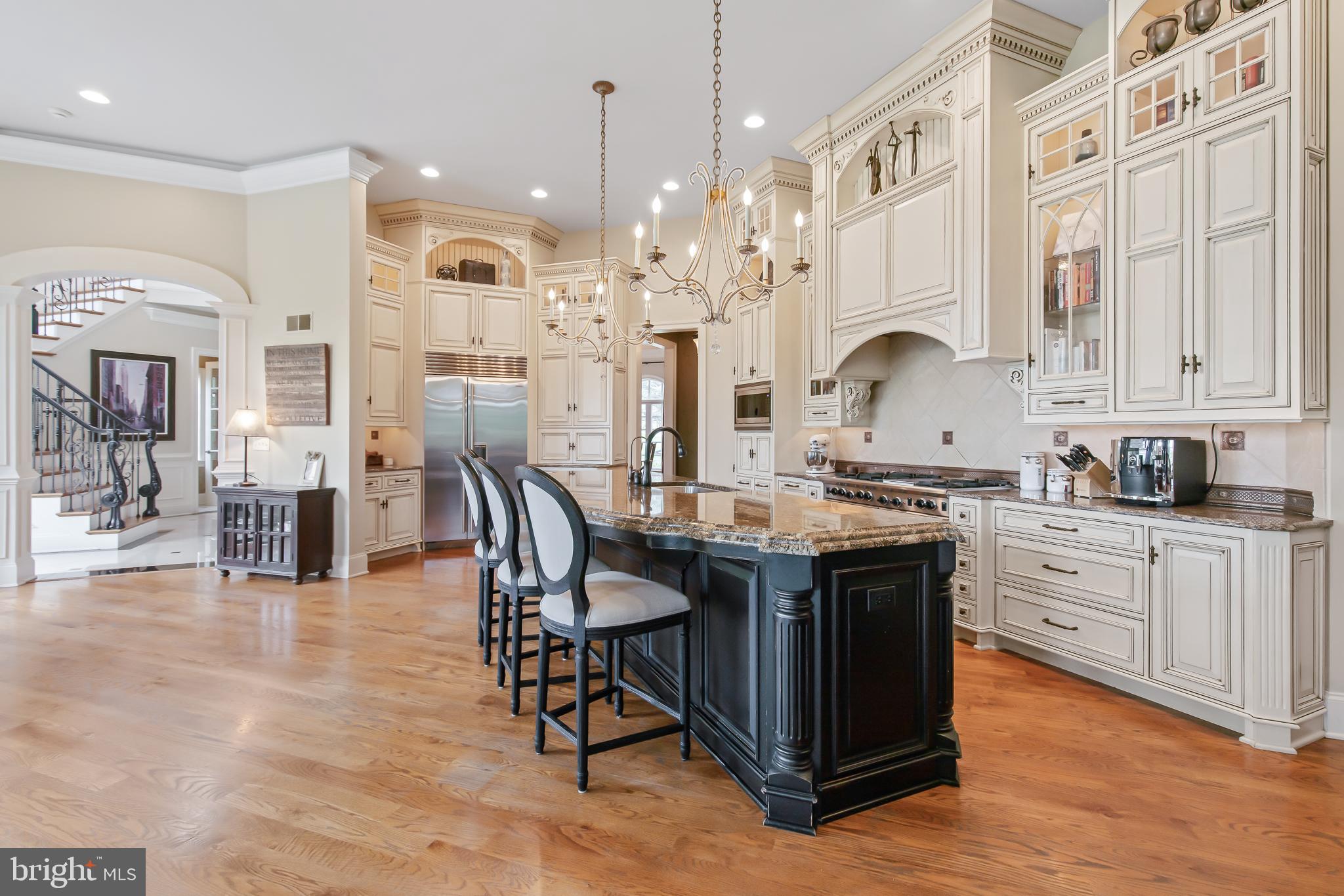 618 Willow Green Lititz, PA 17543 - Photo 23 of 63 a kitchen with stainless steel appliances granite countertop a kitchen island a stove a table a sink cabinets and living room view