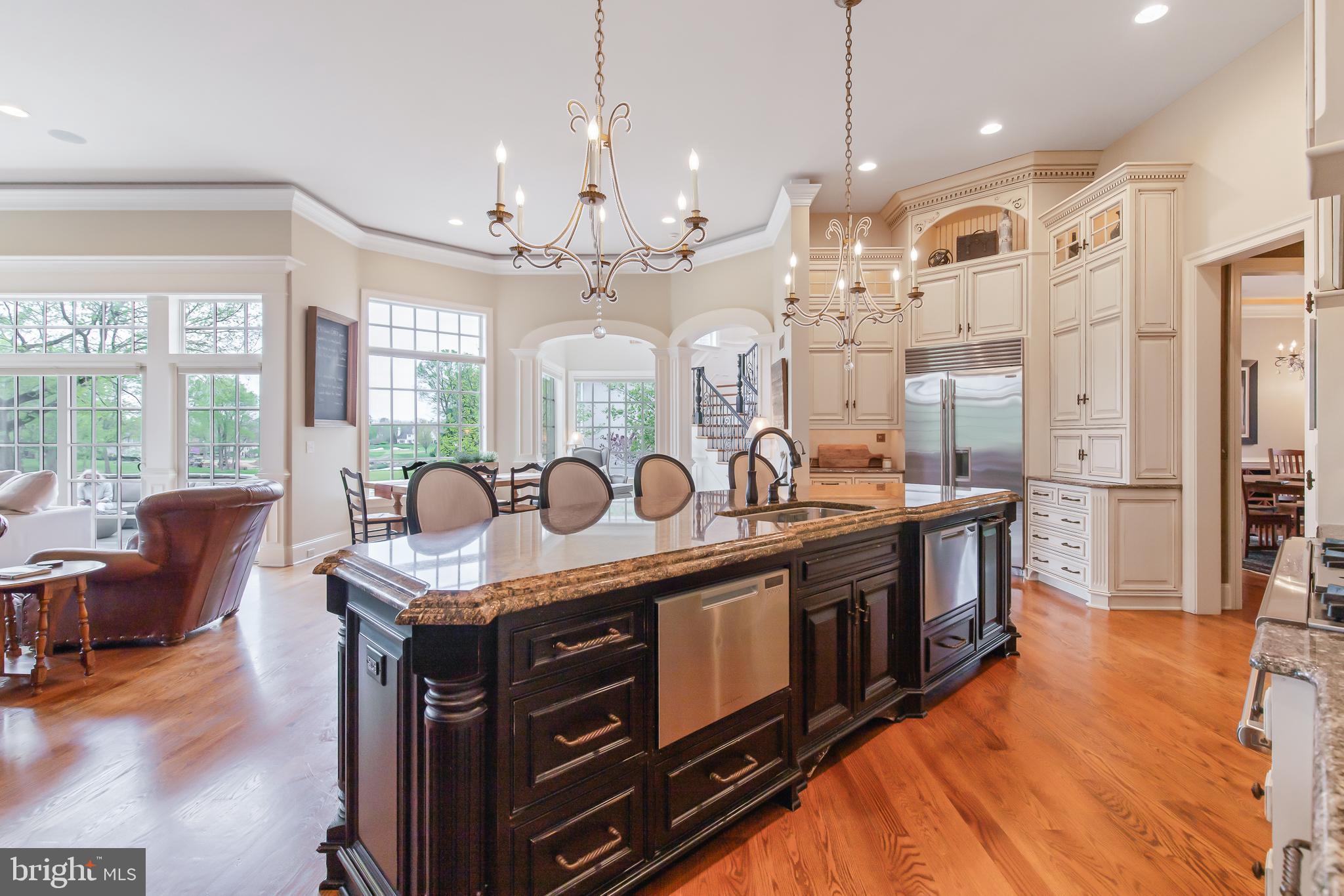 618 Willow Green Lititz, PA 17543 - Photo 24 of 63 a kitchen with stainless steel appliances granite countertop a stove top oven a refrigerator a dining table and chairs with wooden floor