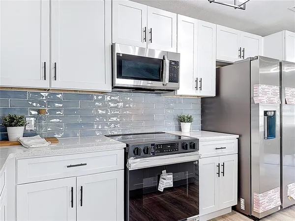a kitchen with a sink cabinets and appliances