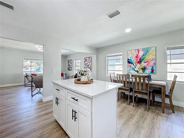a kitchen with stainless steel appliances a stove microwave and sink