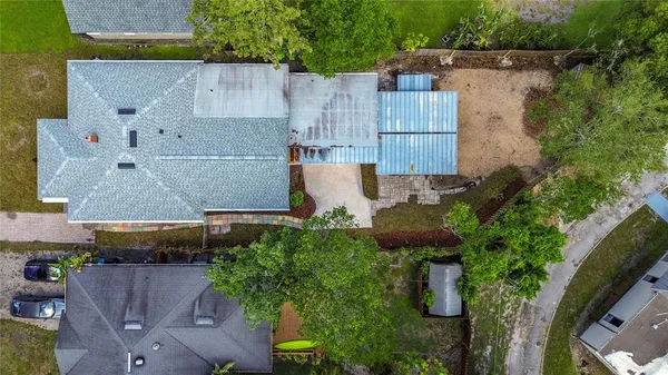 an aerial view of a houses with a yard