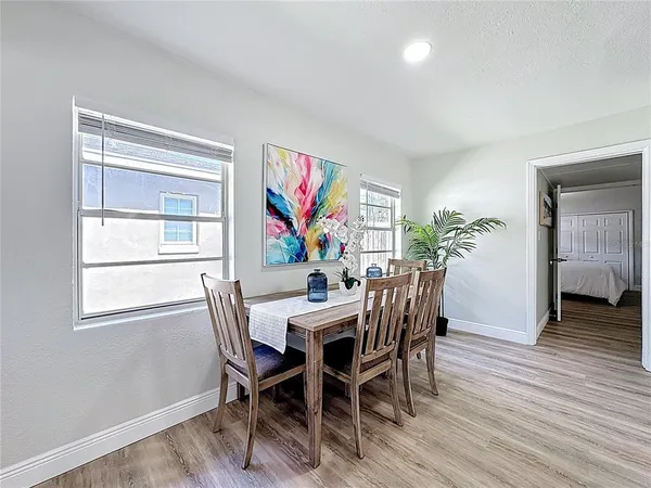 a view of a dining room with furniture window and wooden floor
