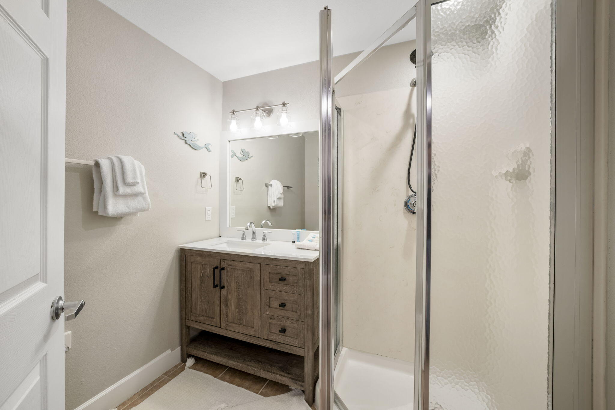 16819 Front Beach Road, Unit 2116 Panama City Beach, FL 32413 - Photo 15 of 51 a bathroom with a granite countertop sink a mirror and shower