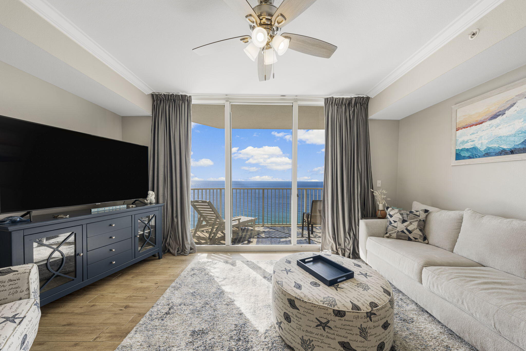 16819 Front Beach Road, Unit 2116 Panama City Beach, FL 32413 - Photo 4 of 51 a living room with furniture and a flat screen tv